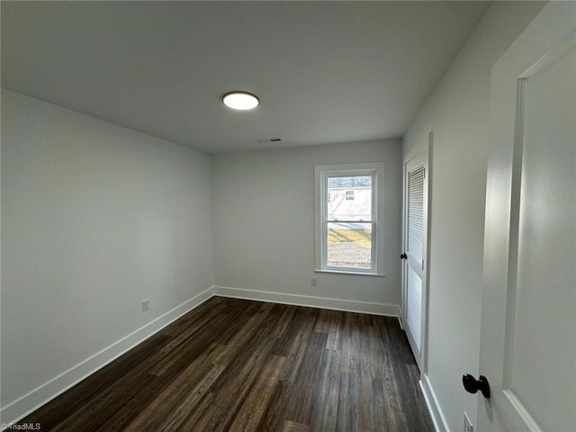 empty room with dark hardwood / wood-style floors