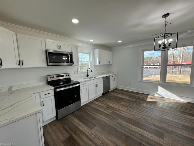 kitchen featuring an inviting chandelier, white cabinetry, stainless steel appliances, pendant lighting, and sink