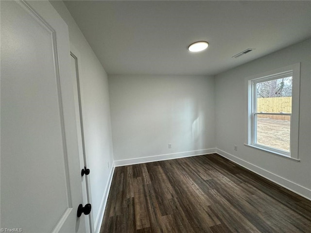 spare room with dark hardwood / wood-style flooring