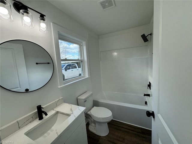 full bathroom featuring toilet, shower / bathtub combination, hardwood / wood-style floors, and vanity