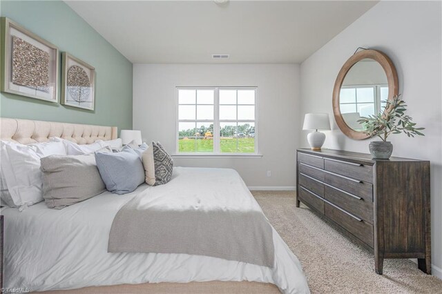 carpeted bedroom featuring multiple windows