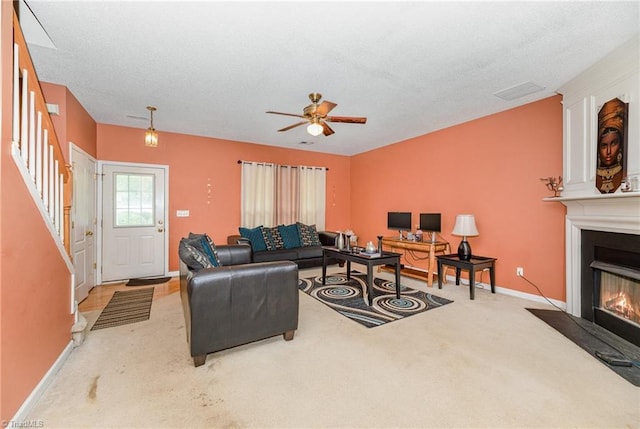 3902 Elizabeth Glen Way, Jamestown, NC 27282 - carpeted living area with a fireplace with flush hearth, ceiling fan, baseboards, and stairway