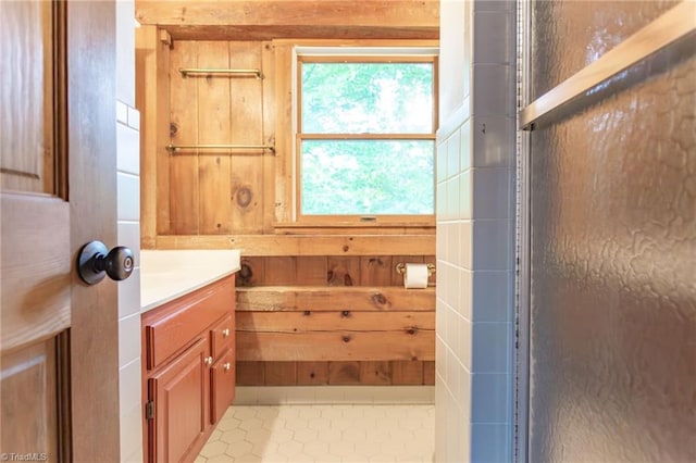 bathroom with wood walls and vanity