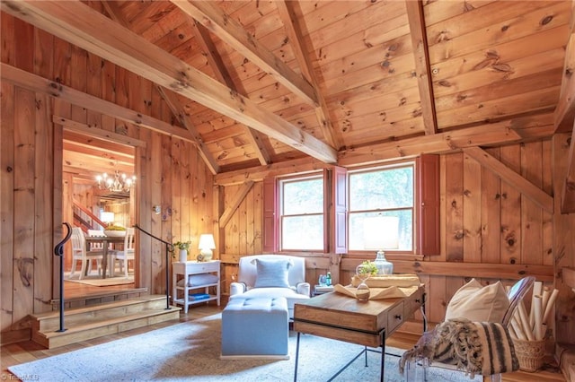 living area featuring wooden walls, lofted ceiling with beams, wood ceiling, wood finished floors, and an inviting chandelier