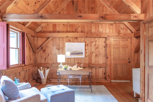 office space featuring wood ceiling, wood walls, lofted ceiling with beams, and wood finished floors