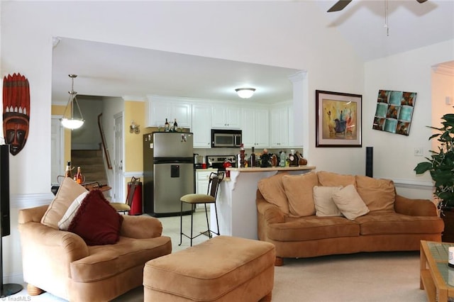 carpeted living room with ceiling fan