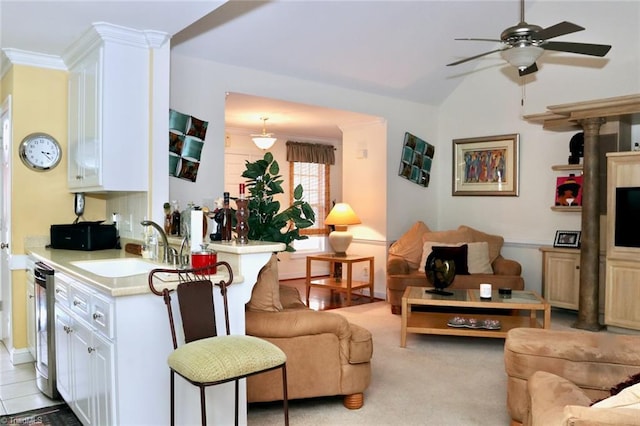 living room with sink, ceiling fan, and light carpet