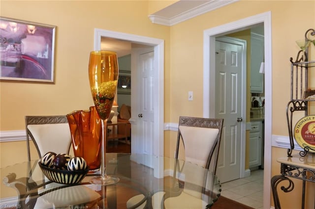 sitting room featuring crown molding and light tile patterned floors