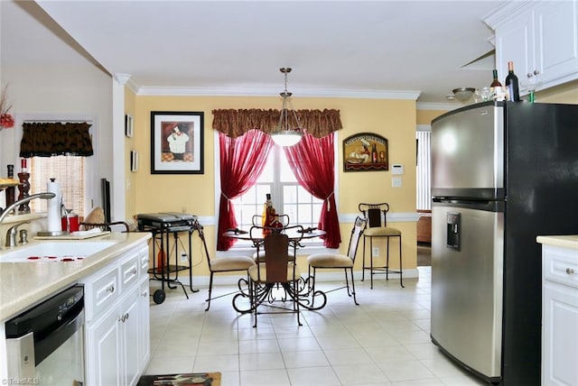 kitchen with decorative light fixtures, white cabinetry, stainless steel appliances, sink, and crown molding