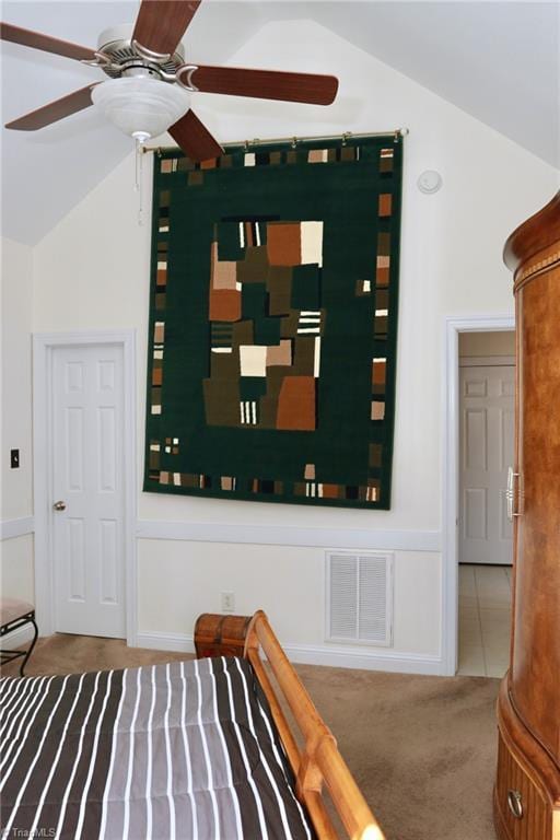 carpeted bedroom with lofted ceiling