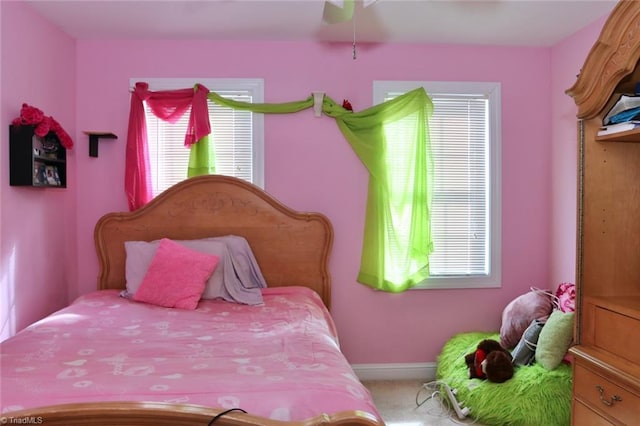 carpeted bedroom with multiple windows