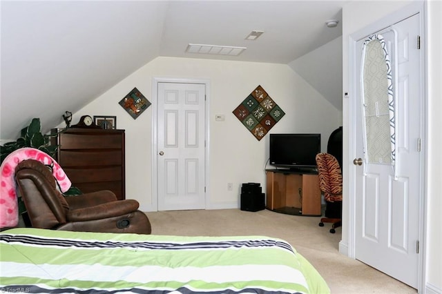 carpeted bedroom featuring a closet and vaulted ceiling