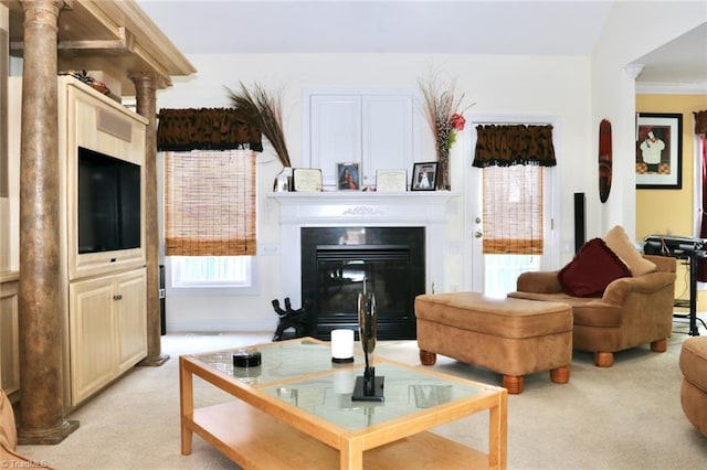 living room featuring decorative columns, light colored carpet, and vaulted ceiling