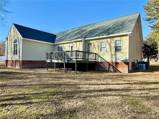 back of property featuring a wooden deck, cooling unit, and a lawn