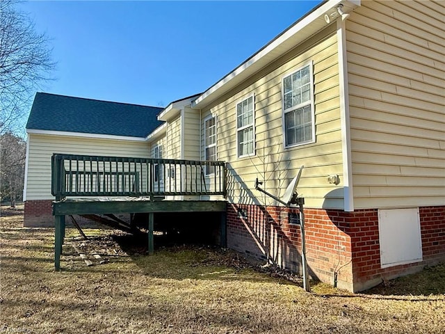 rear view of house featuring a wooden deck