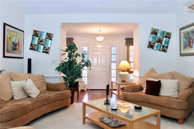 living room featuring light hardwood / wood-style flooring and crown molding