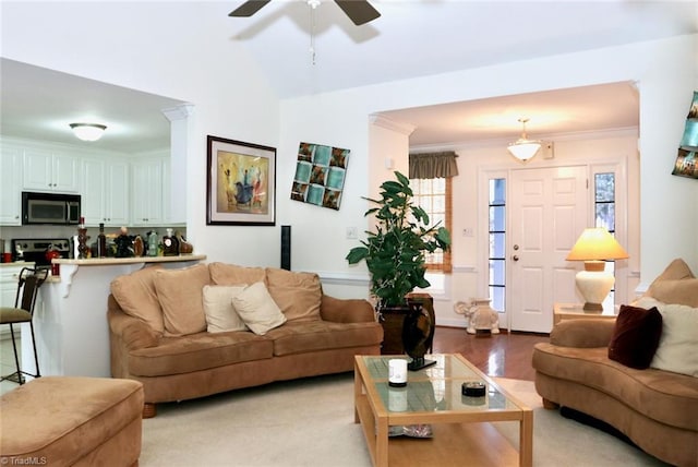 living room featuring light wood-type flooring, ceiling fan, and ornamental molding