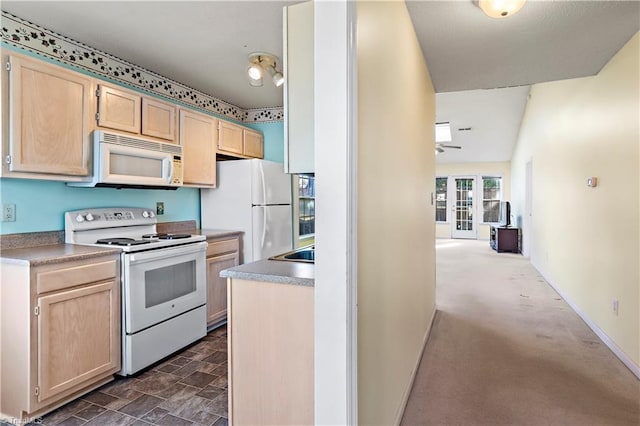 kitchen with light brown cabinets and white appliances