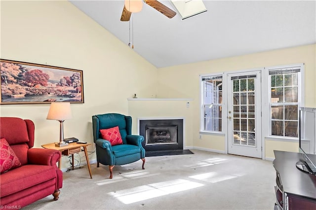 sitting room featuring high vaulted ceiling, light colored carpet, french doors, and ceiling fan