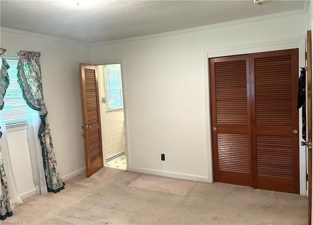 437 Charles Dr, Winston-Salem, NC 27107 - unfurnished bedroom with ornamental molding, a closet, light colored carpet, baseboards, and ensuite bathroom