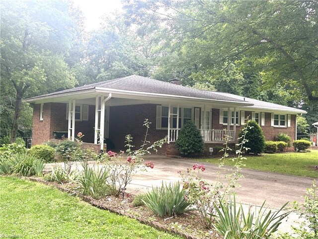 437 Charles Dr, Winston-Salem, NC 27107 - ranch-style home with a porch, brick siding, a front lawn, and driveway