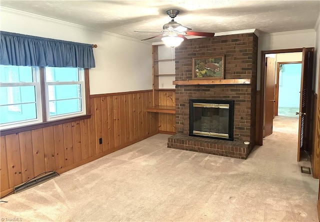 437 Charles Dr, Winston-Salem, NC 27107 - unfurnished living room with a ceiling fan, wainscoting, carpet, ornamental molding, and a fireplace