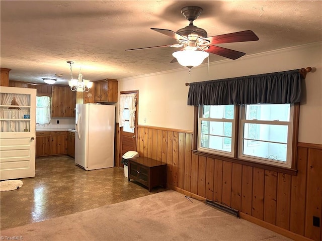 437 Charles Dr, Winston-Salem, NC 27107 - kitchen with freestanding refrigerator, healthy amount of natural light, a wainscoted wall, a textured ceiling, and wooden walls