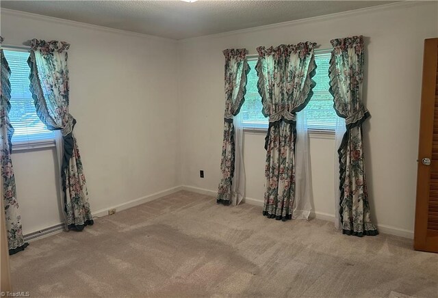 437 Charles Dr, Winston-Salem, NC 27107 - spare room featuring healthy amount of natural light, crown molding, carpet flooring, and baseboards