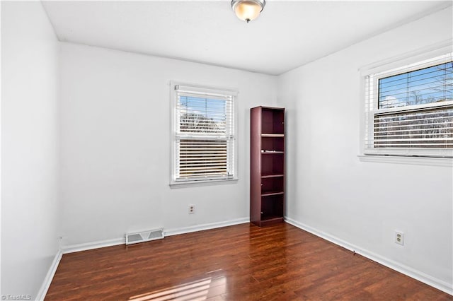 empty room featuring dark hardwood / wood-style flooring