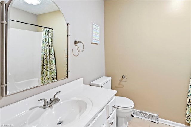 bathroom featuring vanity, tile patterned floors, toilet, and walk in shower