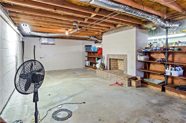 basement featuring a brick fireplace