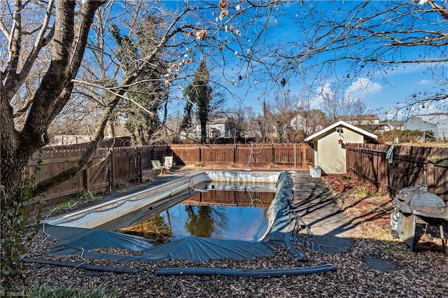 view of swimming pool with a storage unit