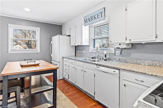 kitchen featuring a healthy amount of sunlight, sink, white cabinets, and white appliances