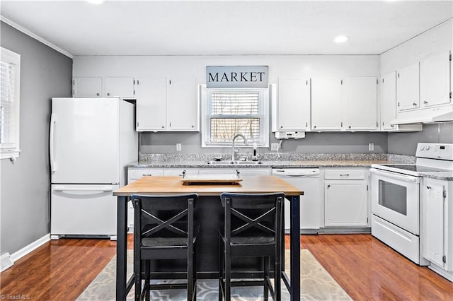 kitchen featuring sink, white cabinetry, a center island, white appliances, and hardwood / wood-style floors