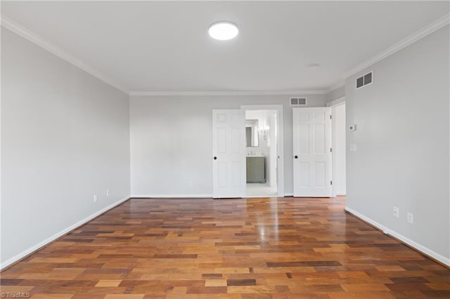 empty room with hardwood / wood-style flooring and ornamental molding