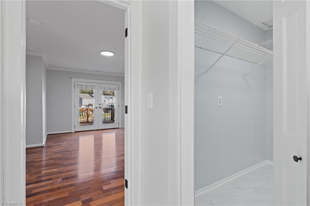 hall featuring wood-type flooring, crown molding, and french doors