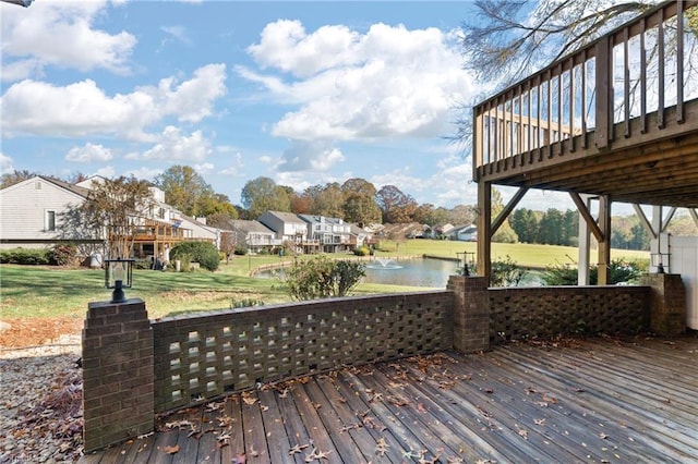 wooden deck featuring a yard and a water view