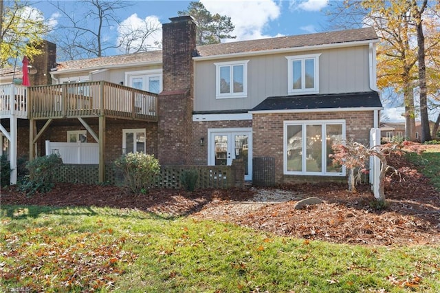 back of property with a wooden deck and french doors