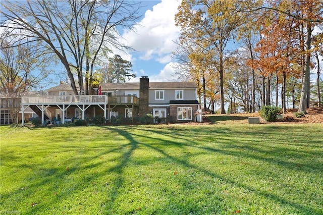 back of property with a lawn and a wooden deck