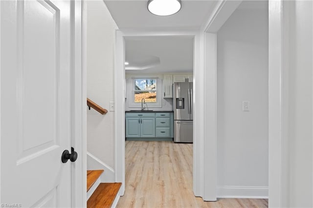 corridor featuring light hardwood / wood-style floors and sink