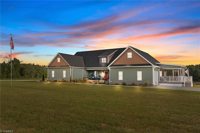 view of front of property with a yard and covered porch