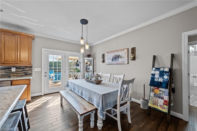 dining space featuring ornamental molding and dark wood-type flooring