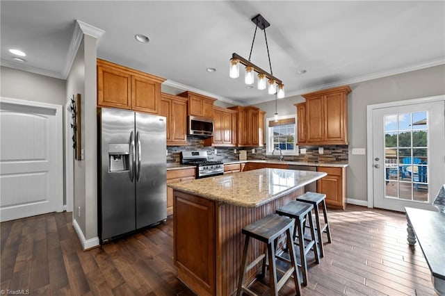 kitchen featuring tasteful backsplash, decorative light fixtures, dark wood-type flooring, stainless steel appliances, and a center island