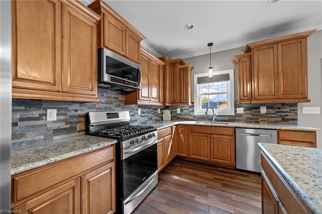 kitchen featuring sink, hanging light fixtures, appliances with stainless steel finishes, dark hardwood / wood-style flooring, and ornamental molding