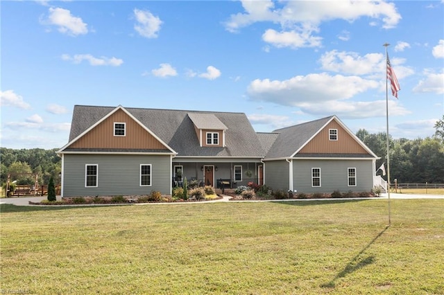 craftsman inspired home featuring covered porch and a front yard