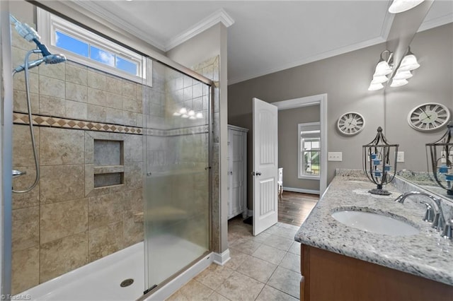 bathroom featuring walk in shower, ornamental molding, vanity, and tile patterned floors