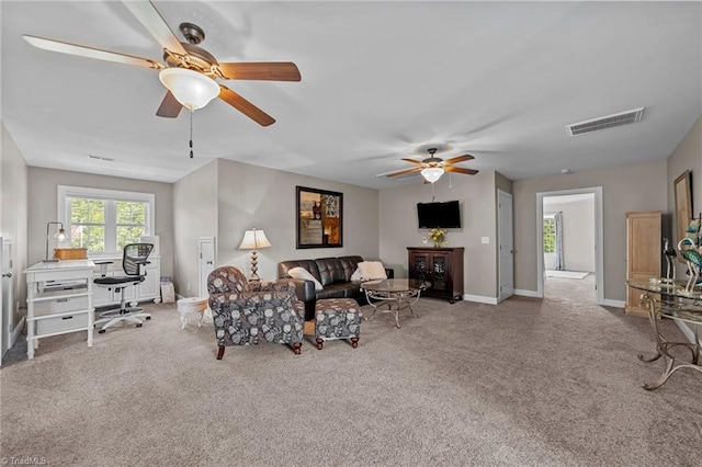 living room featuring ceiling fan and light colored carpet