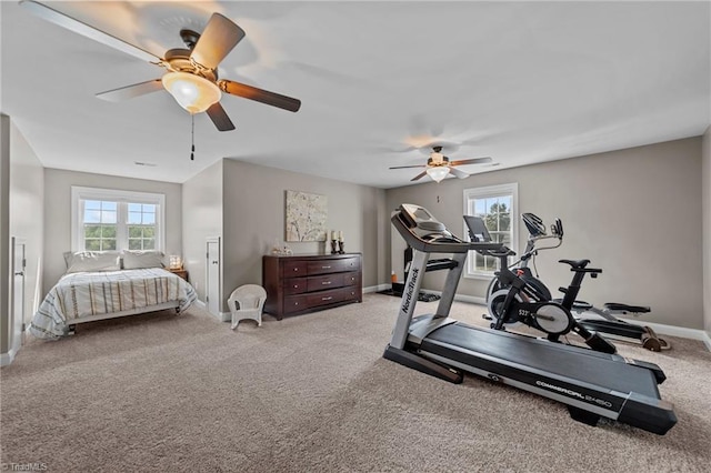 workout area featuring light carpet and ceiling fan