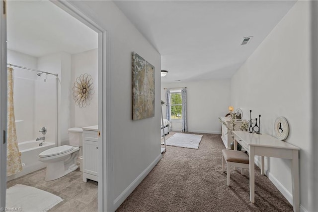 hallway featuring light colored carpet