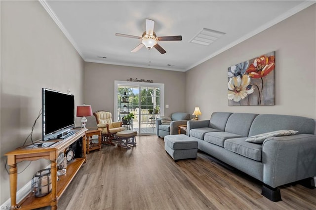 living room featuring ceiling fan, hardwood / wood-style floors, and crown molding